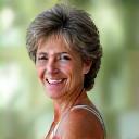 Maria, a 55-year-old woman, looking calm and radiant, possibly after a gentle workout or meditation, exuding a sense of well-being.
